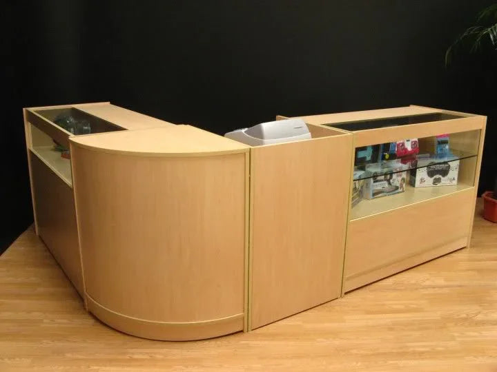 Curved wooden Cosmos Counter Set with glass display sections, showcasing a light maple finish and modern design, ideal for retail spaces