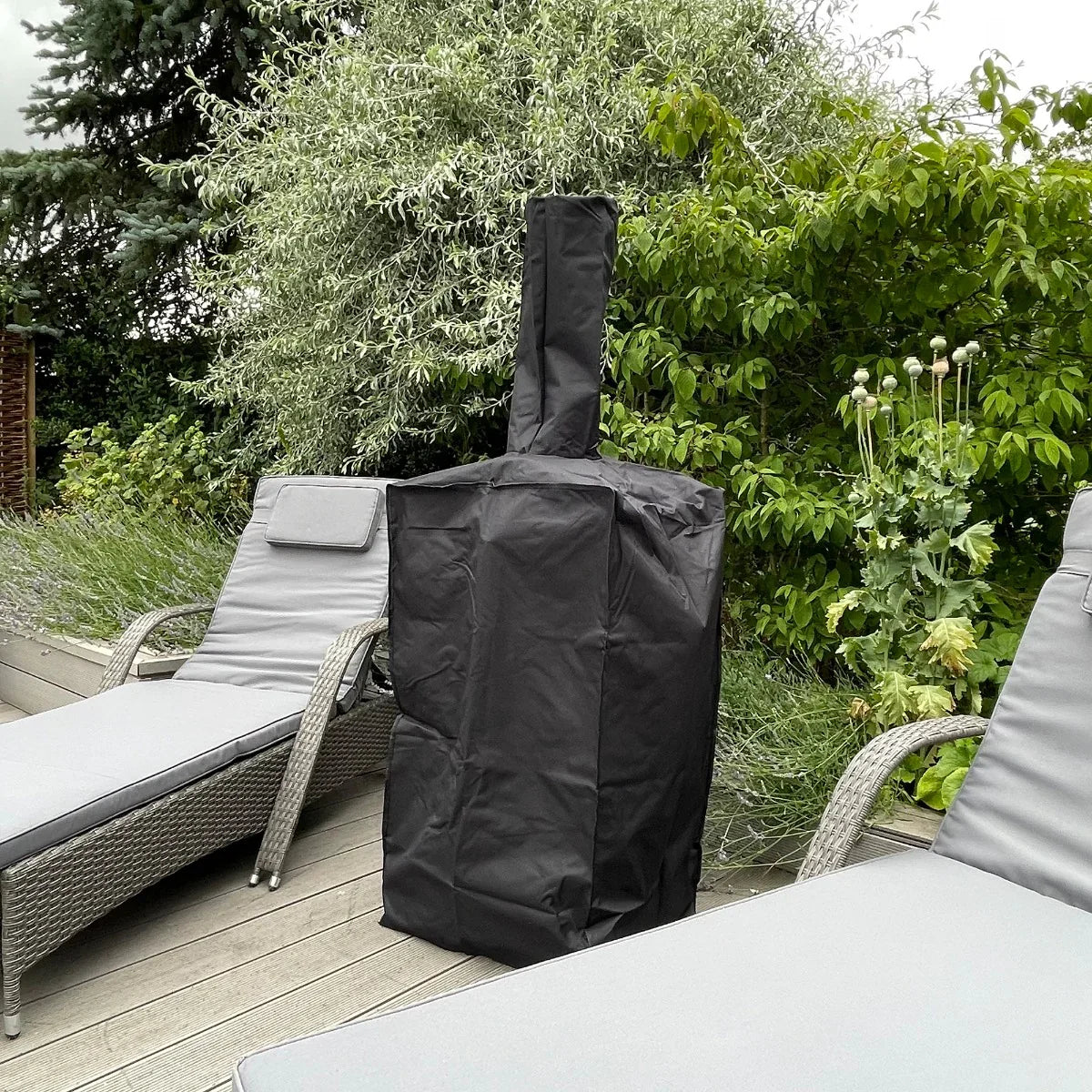 Durable black rain cover for Kukoo outdoor pizza oven, designed to protect from weather elements, shown on a patio among greenery