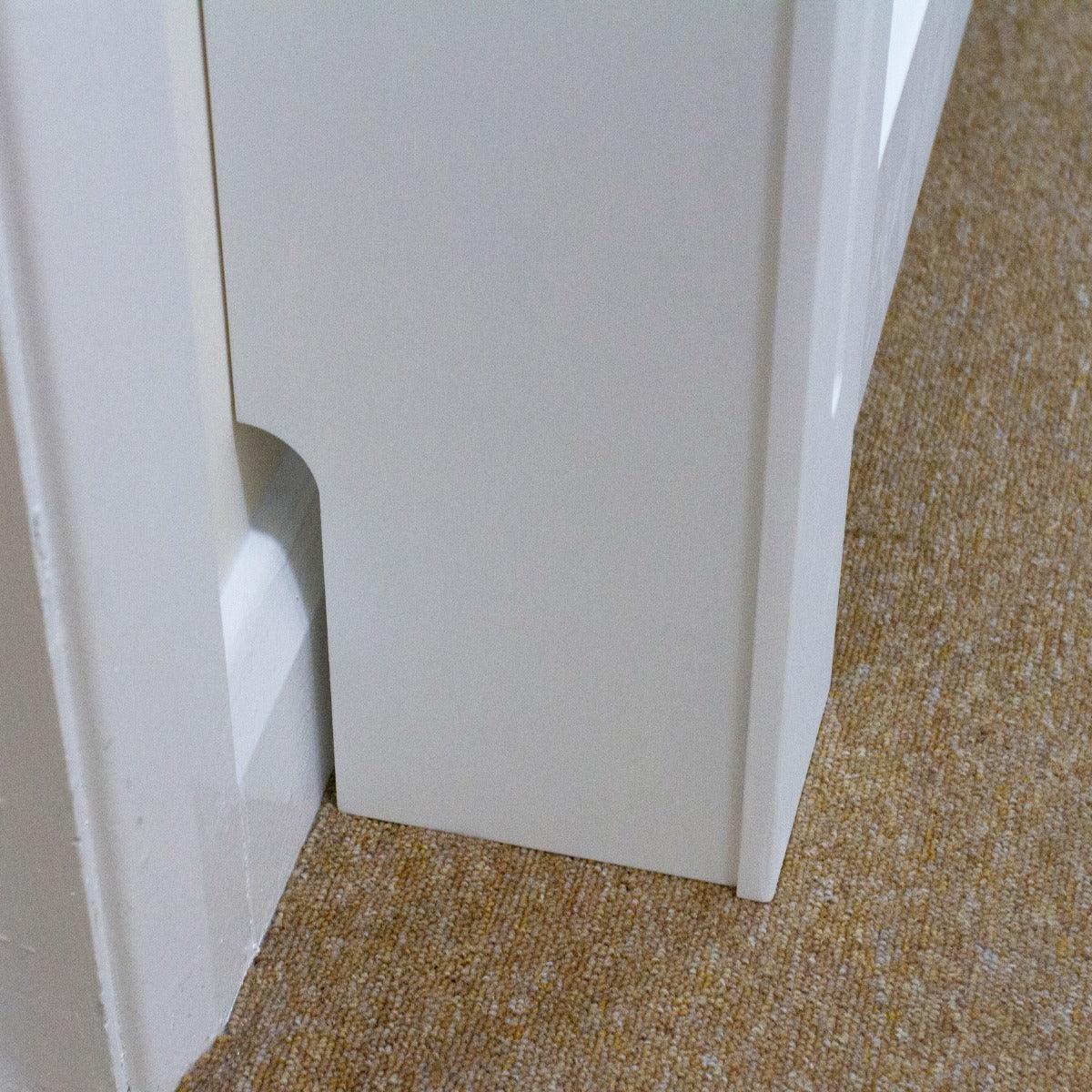 Sleek white MDF radiator cover with a smooth finish, designed to fit snugly against walls, enhancing room aesthetics
