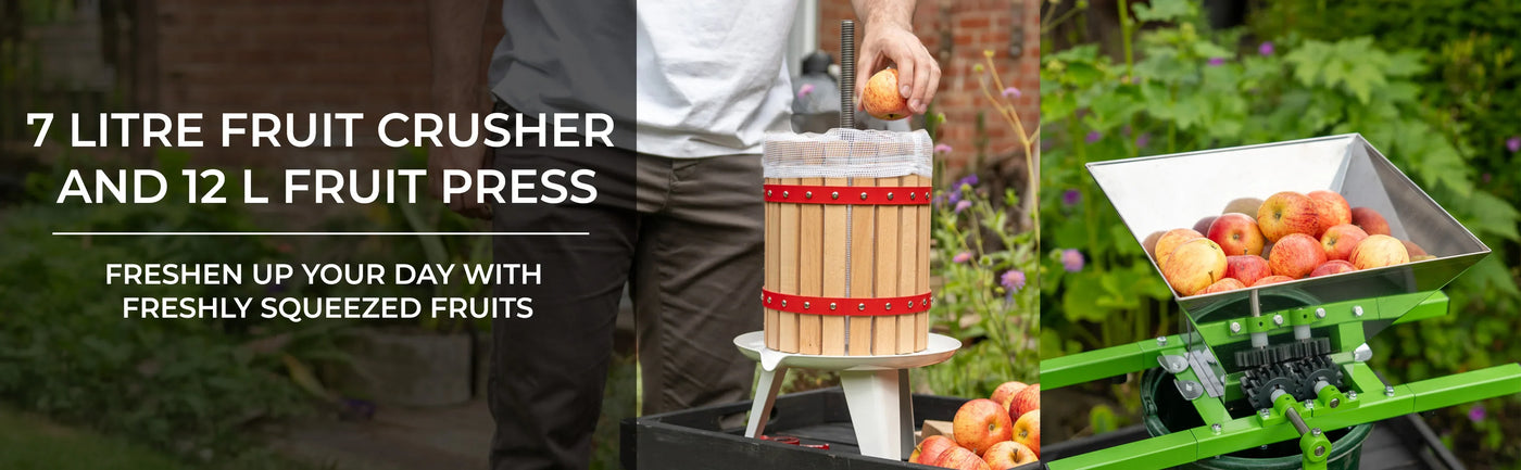 7 litre fruit crusher with wooden barrel and 12 litre fruit press, surrounded by fresh apples in a vibrant garden setting