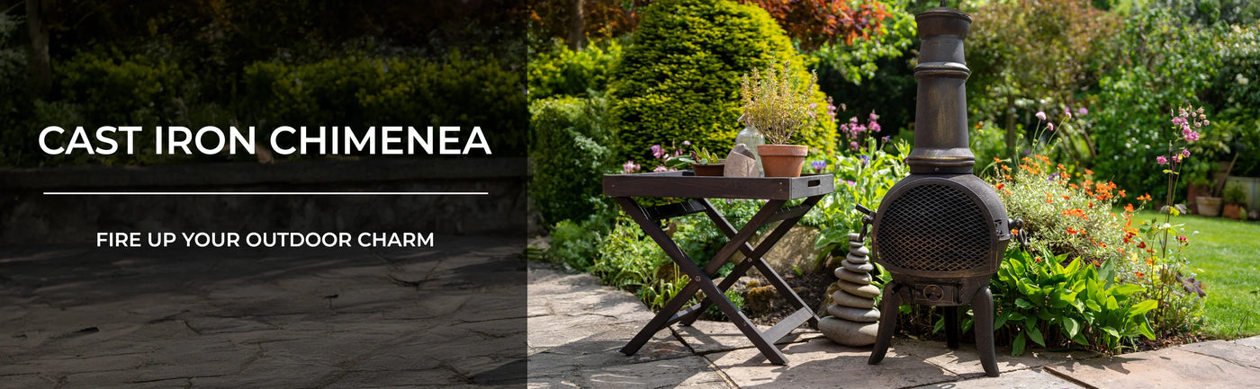 Rustic cast iron chimenea beside a wooden side table, surrounded by vibrant garden flowers and lush greenery, creating a cozy outdoor atmosphere
