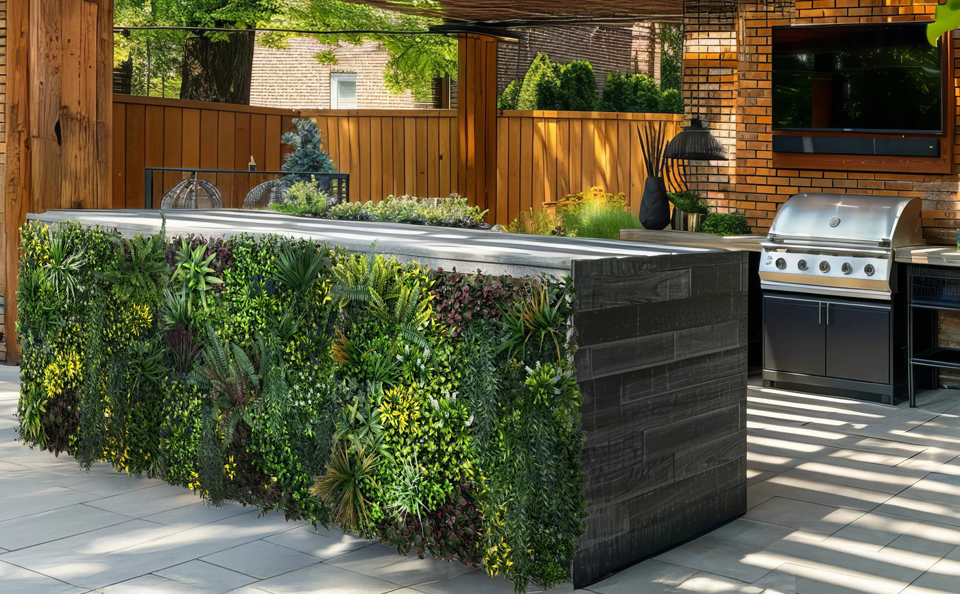 Modern outdoor kitchen featuring a lush green vertical garden, sleek dark wood bar, stainless steel grill, and vibrant landscaping