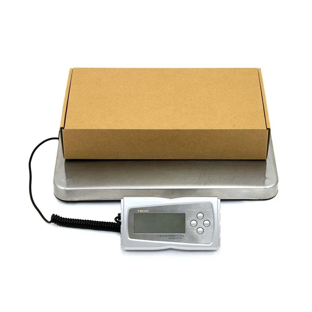 Heavy duty postal scales with a stainless steel platform, digital display, and a cardboard box ready for weighing