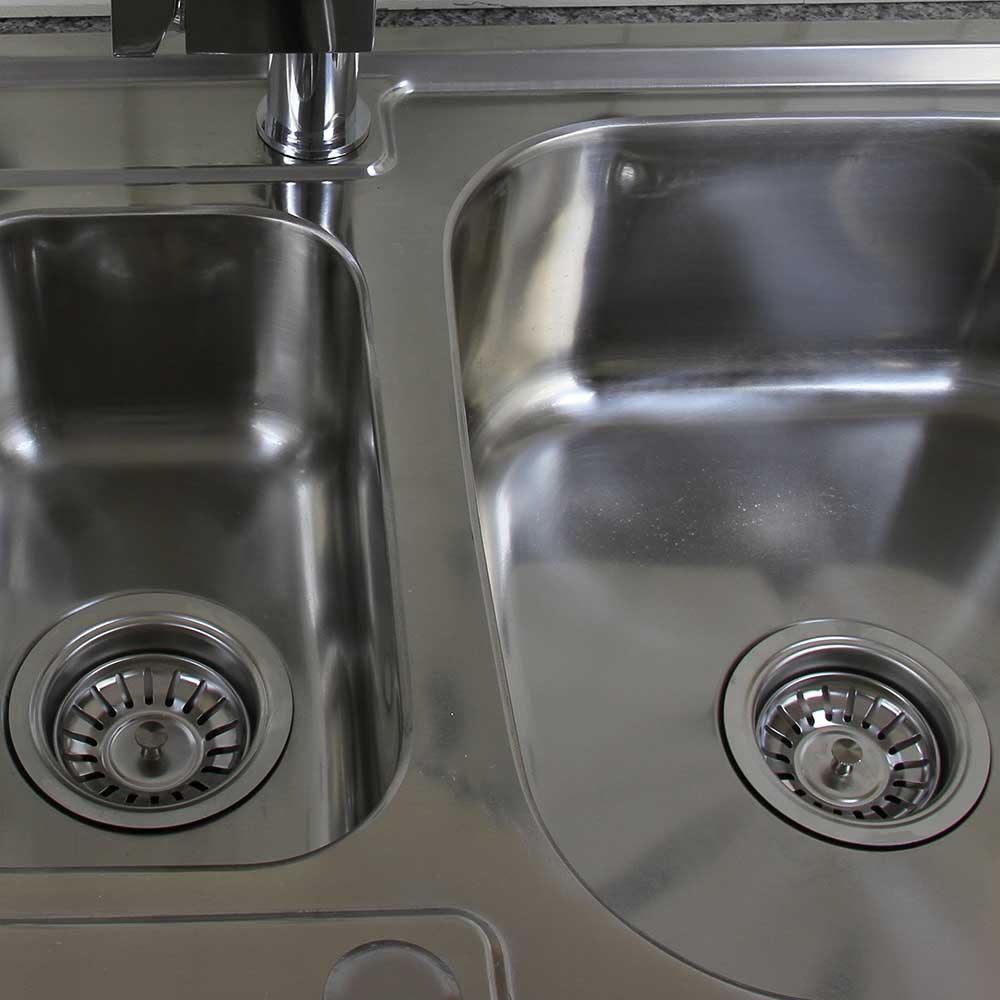 Premium stainless steel kitchen sink with dual basins, polished finish, and sleek drain covers, ideal for modern kitchens
