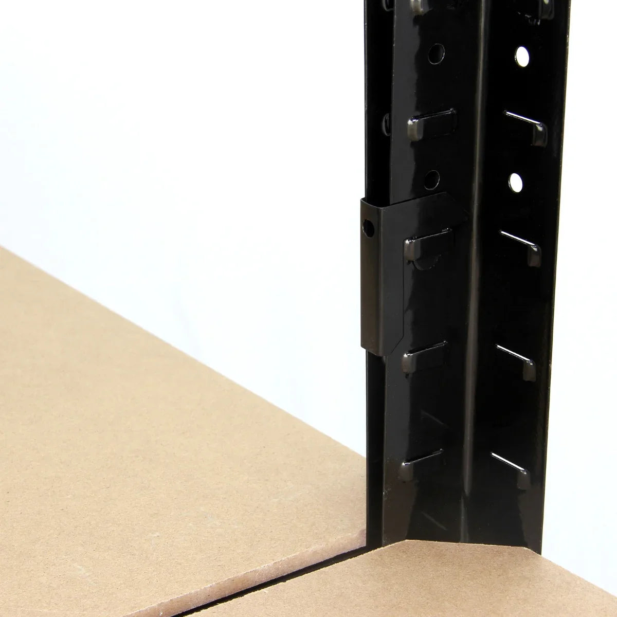 Close-up of T-RAX black metal racking unit showing sturdy frame, adjustable shelving slots, and smooth MDF surface for storage solutions