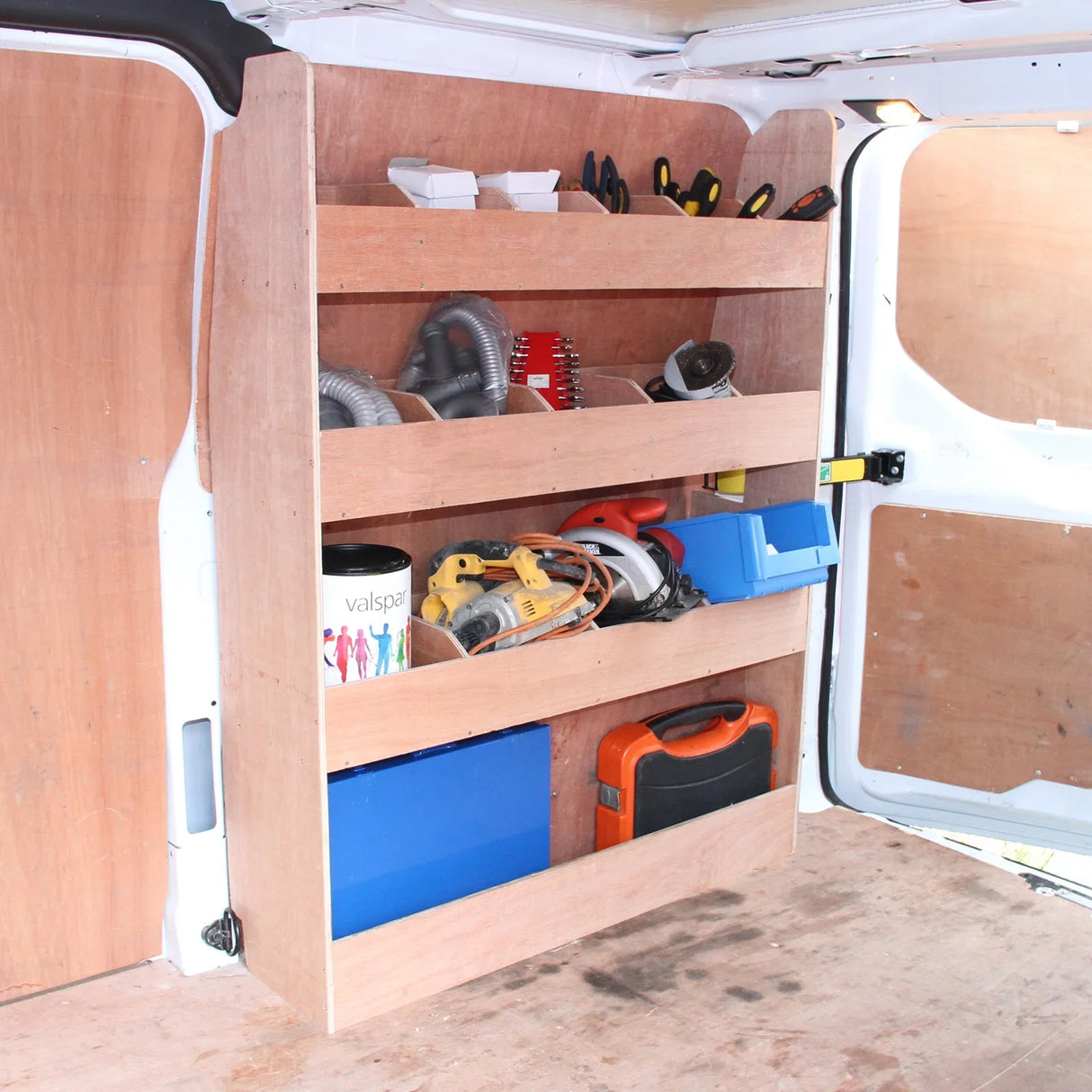 Anthracite van lining with wooden shelves, tools, and storage boxes organized inside a Ford Transit Custom van interior