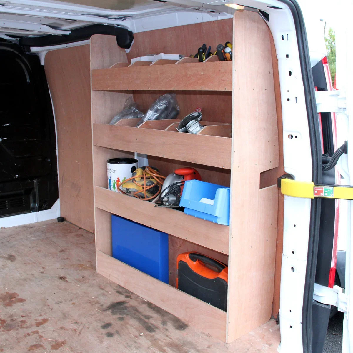 Smoke grey van lining with a wooden racking unit featuring three shelves, tools, and storage boxes inside a Ford Transit...