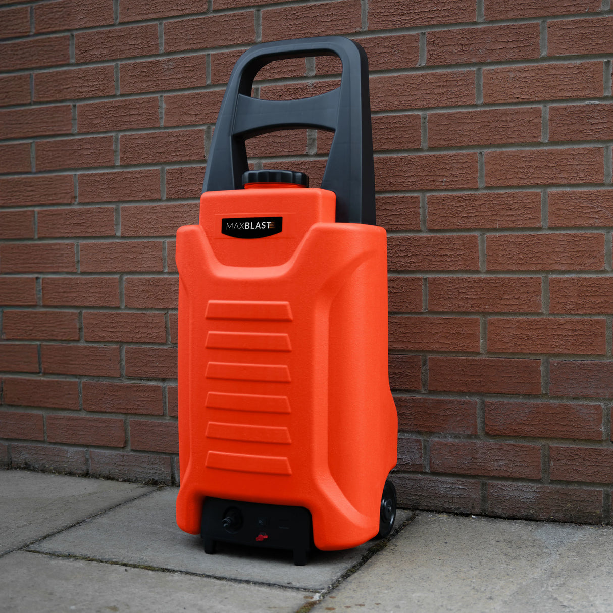 30L Water Trolley in bright orange, featuring a sturdy handle, wheels for easy transport, and textured surface for grip against a brick wall