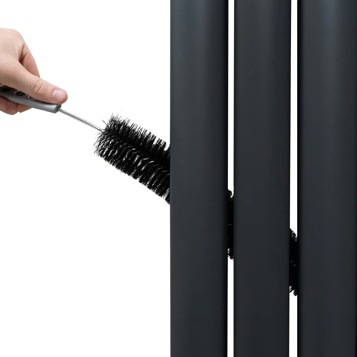 Anthracite grey oval mirror radiator with sleek vertical bars, being cleaned with a brush for easy maintenance and modern style