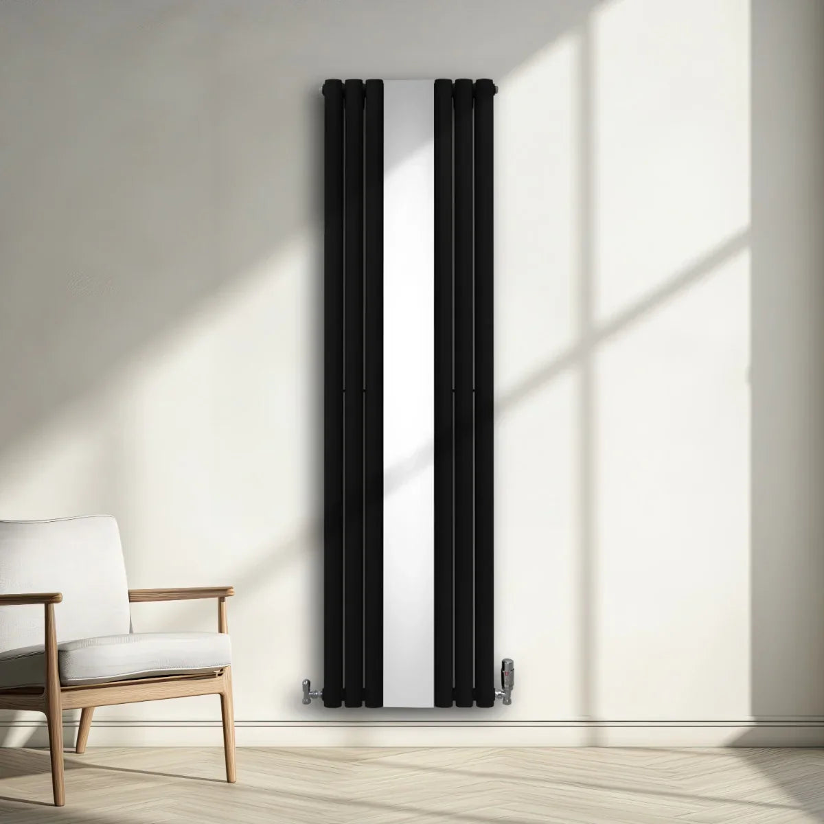 Sleek black oval mirror radiator with vertical bars, 1800mm x 500mm, mounted on a light wall beside a modern chair in a sunlit room