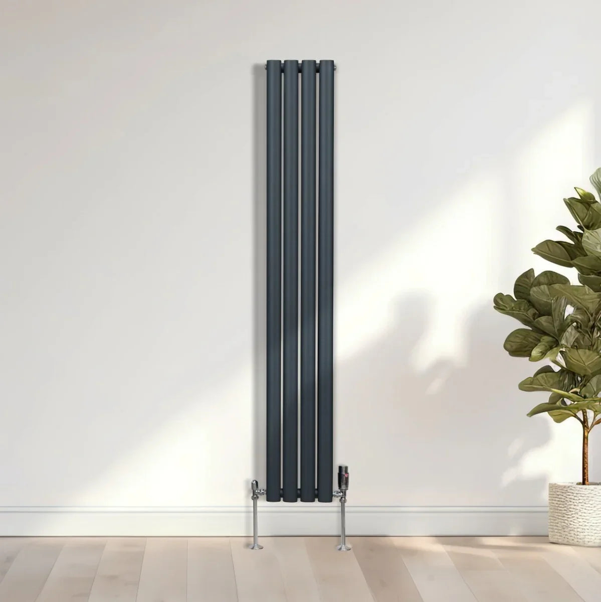 Anthracite grey oval column radiator, 1600mm x 240mm, featuring sleek vertical lines and modern valves, set against a light wall and wooden floor