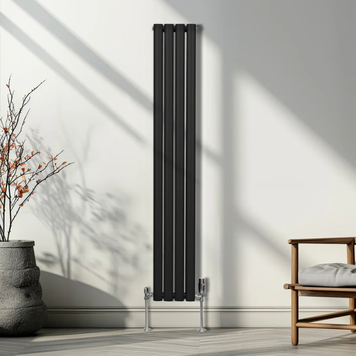 Sleek black oval column radiator with polished valves, standing tall against a light wall, enhancing modern interior decor