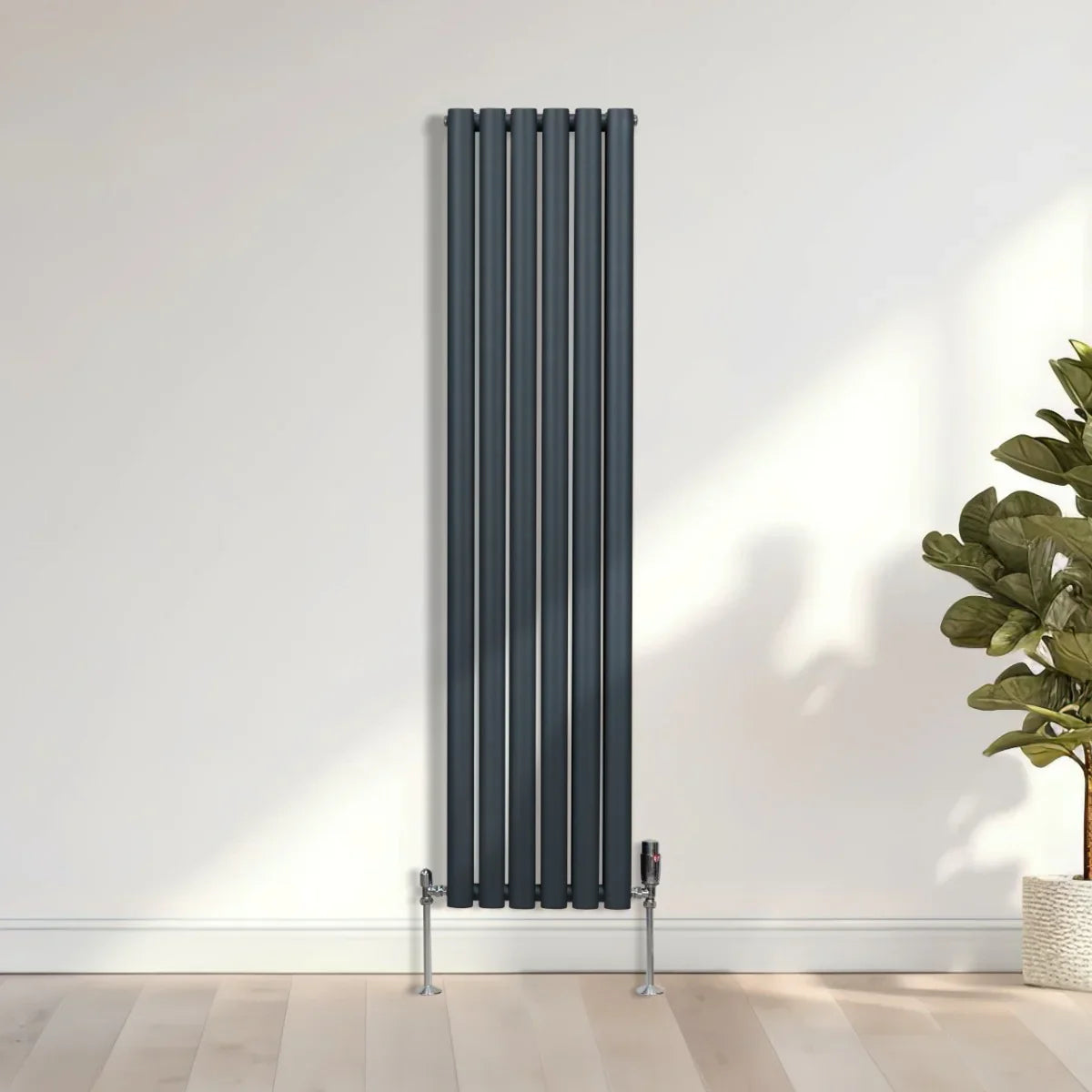 Oval column radiator in anthracite grey, 1600mm x 360mm, featuring sleek vertical lines and modern valve, set against a light wall
