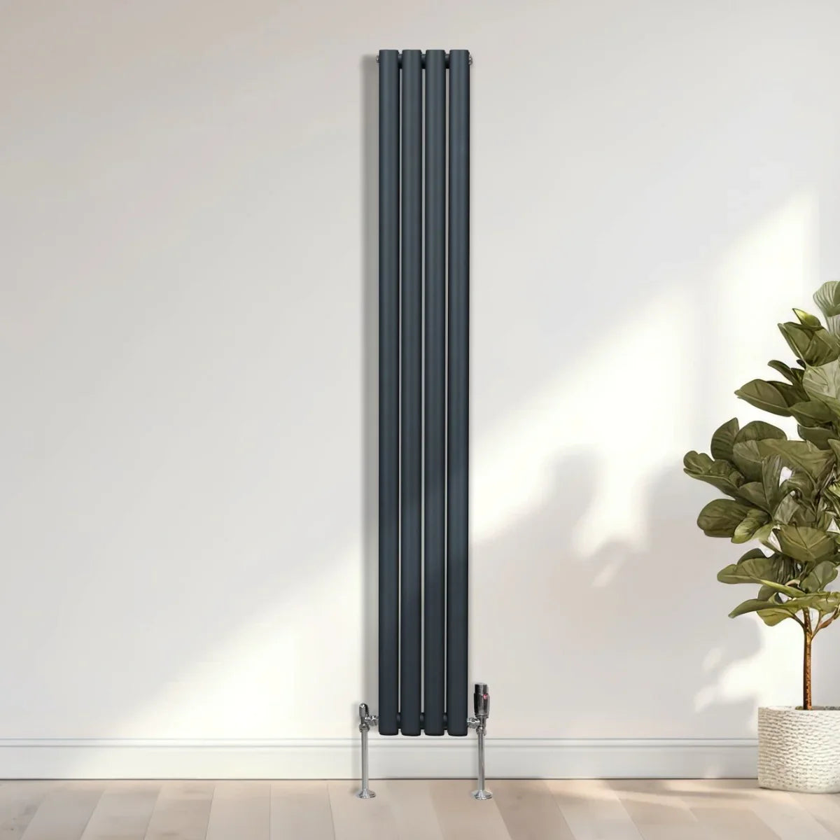 Anthracite grey oval column radiator, 1800mm x 240mm, featuring sleek vertical design and modern valves against a light wall