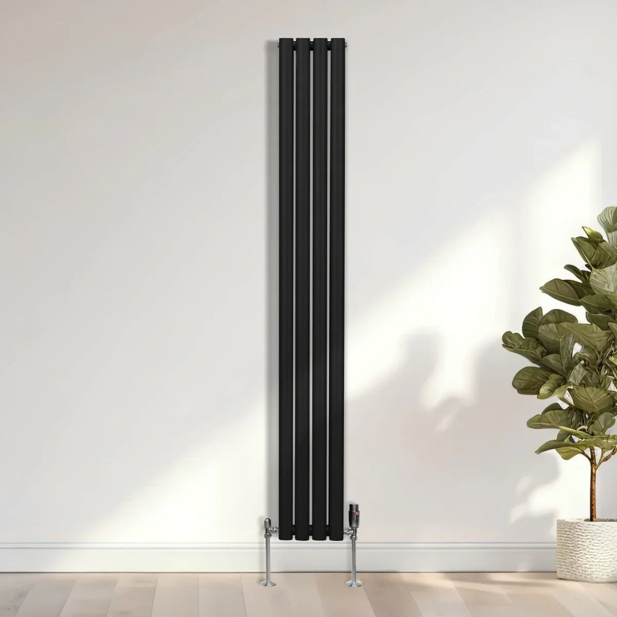 Sleek black oval column radiator with chrome valves, measuring 1800mm x 240mm, mounted on a light wall in a modern setting