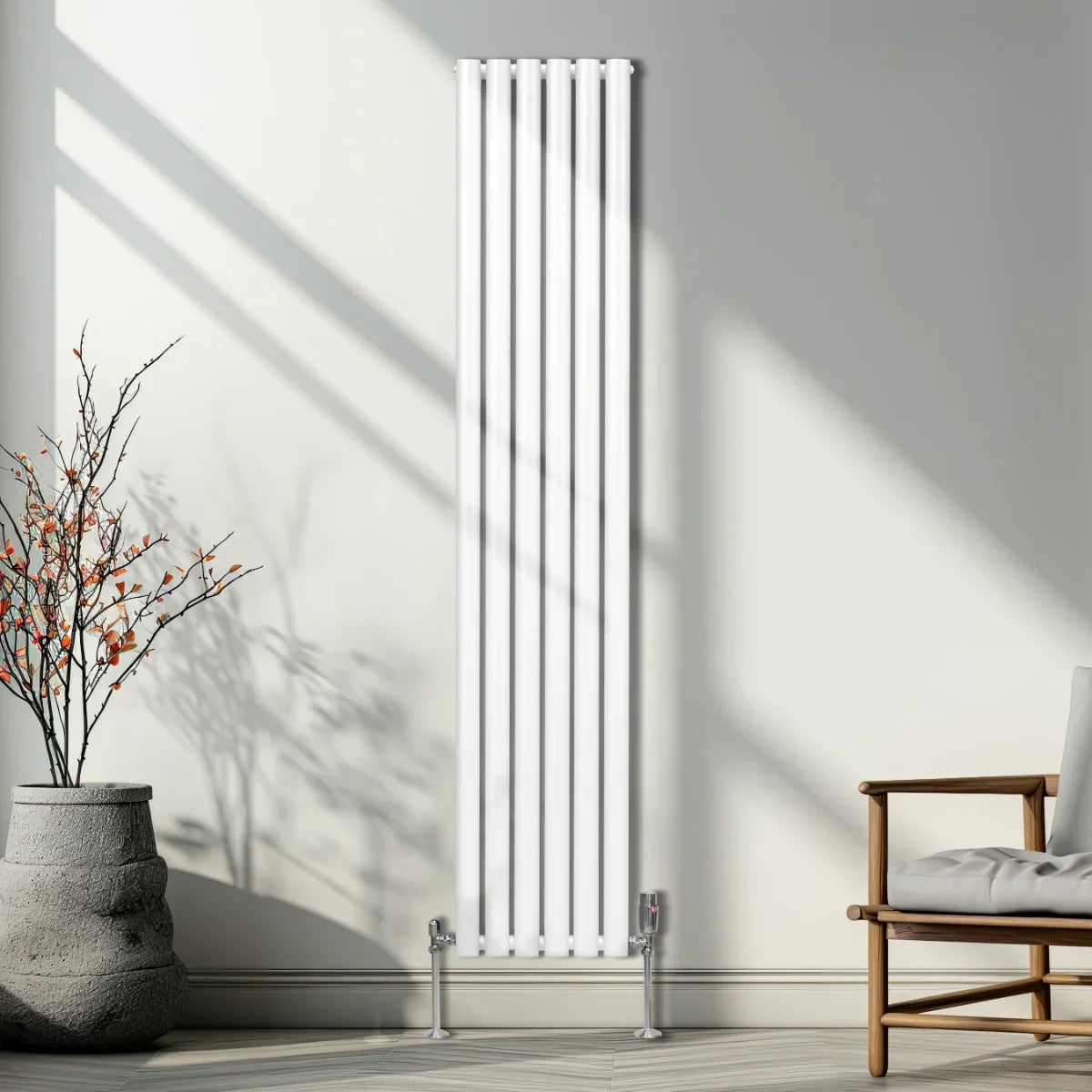 Sleek white oval column radiator with six vertical panels, standing on chrome feet, set against a modern interior with natural light