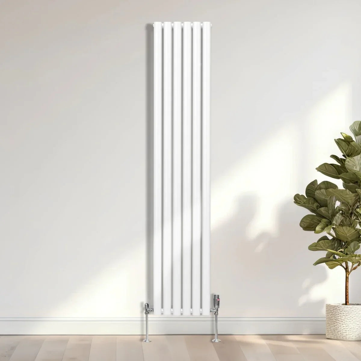 Sleek white oval column radiator with vertical bars, measuring 1800mm x 360mm, complemented by chrome valves and a modern setting