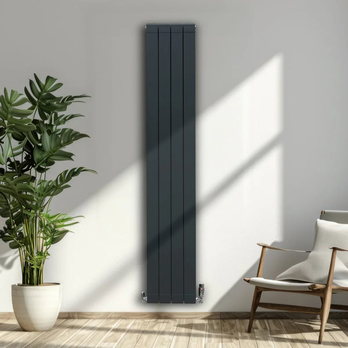 Anthracite grey aluminium radiator, 1800mm x 315mm, featuring a sleek vertical design, mounted on a light wall with natural sunlight
