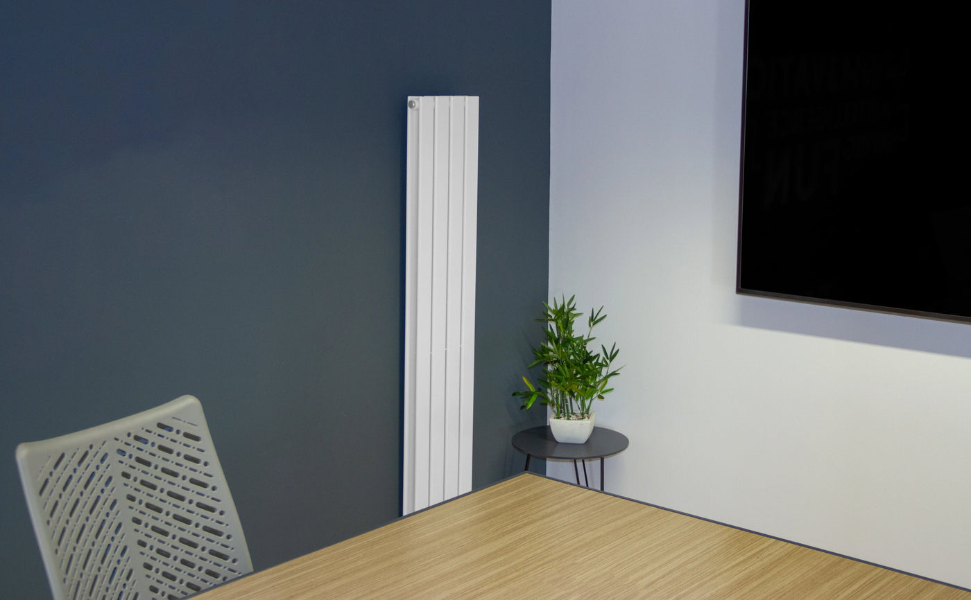 Modern office space featuring a sleek wooden table, minimalist chair, green potted plant, and a tall white radiator against a dark wall