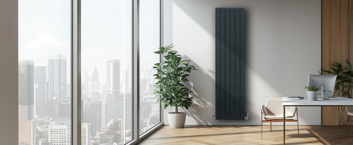 Sleek vertical radiator in a modern office with large windows, potted plant, and minimalist furniture, enhancing the contemporary aesthetic