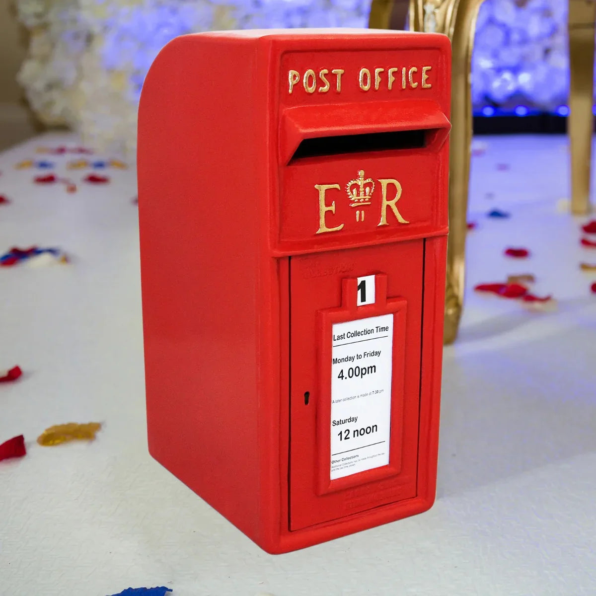 Bright red Royal Mail post box featuring the crown emblem, collection times displayed, and a classic design perfect for decor