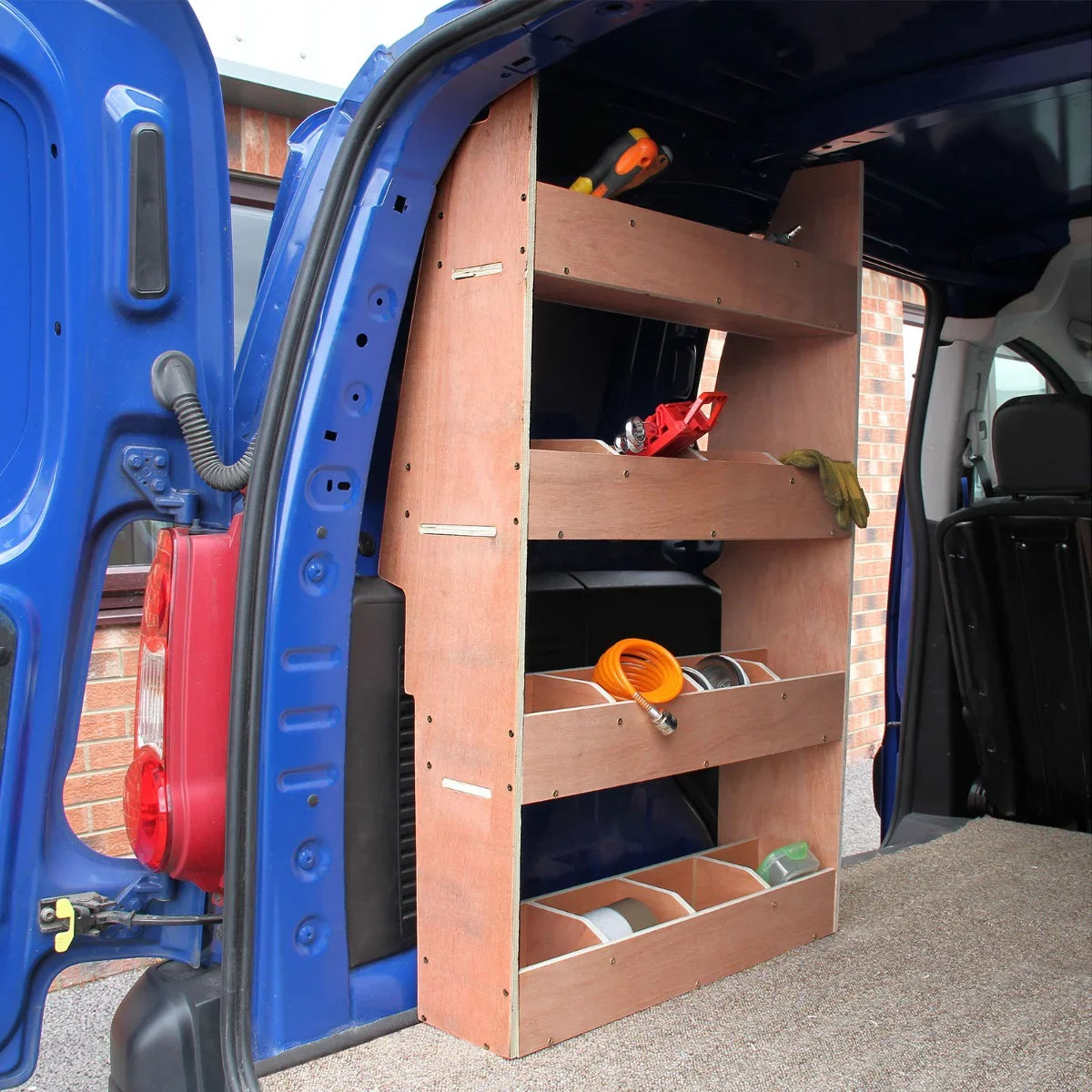 Silver grey van lining with a wooden racking unit featuring three shelves, tools, and storage bins inside a Citroen Berlingo