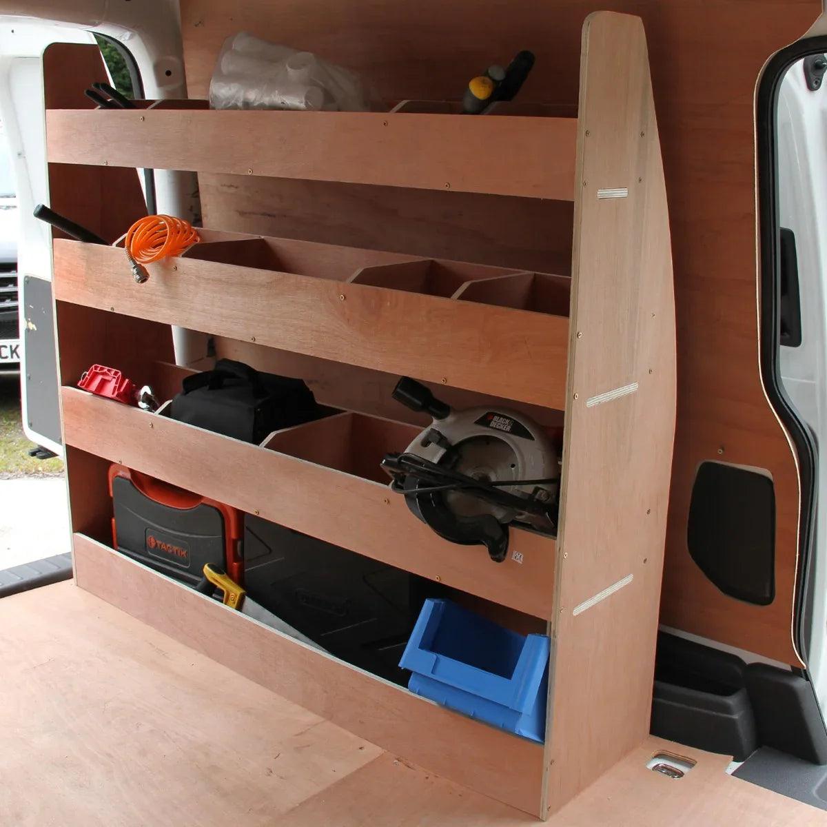 Smoke grey van lining with a wooden racking unit featuring multiple storage compartments for tools and equipment