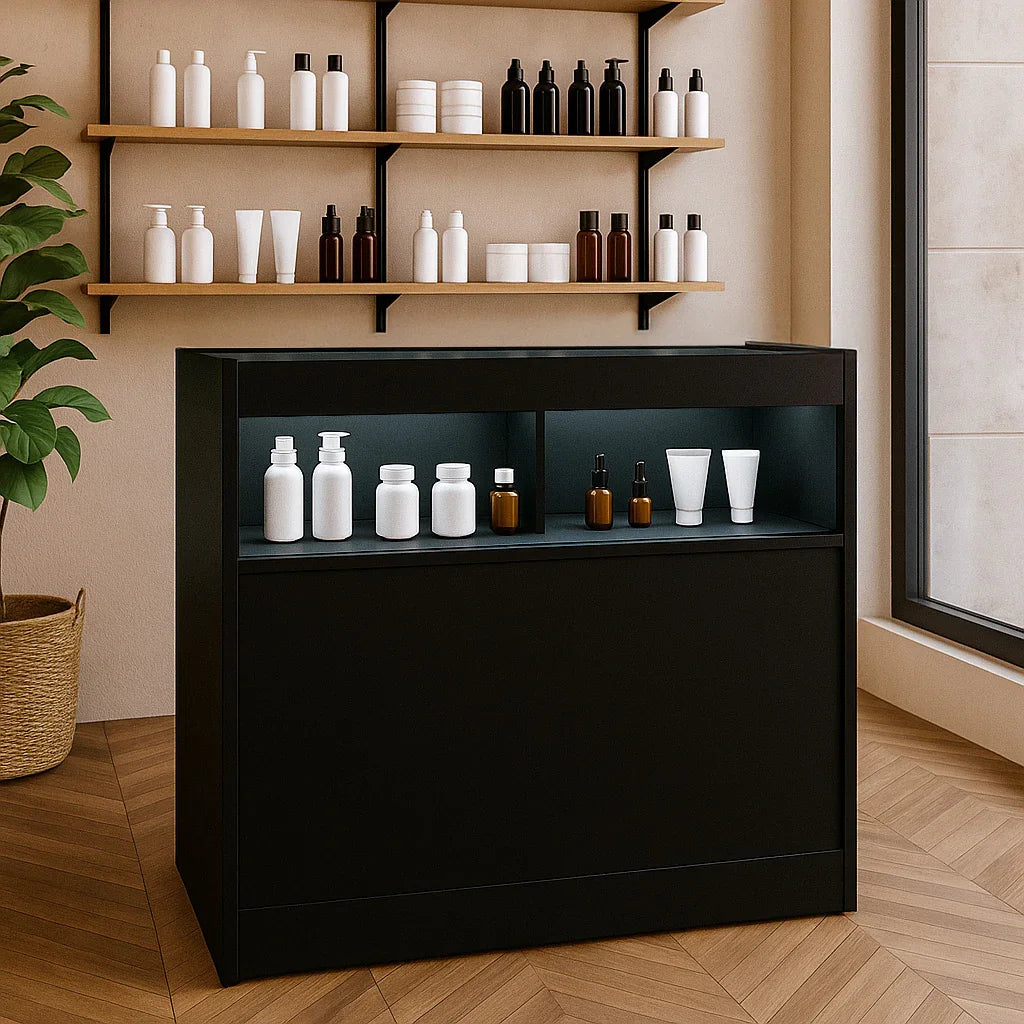 Sleek black LED retail shop counter B900 with illuminated display, showcasing various white and brown cosmetic bottles on top