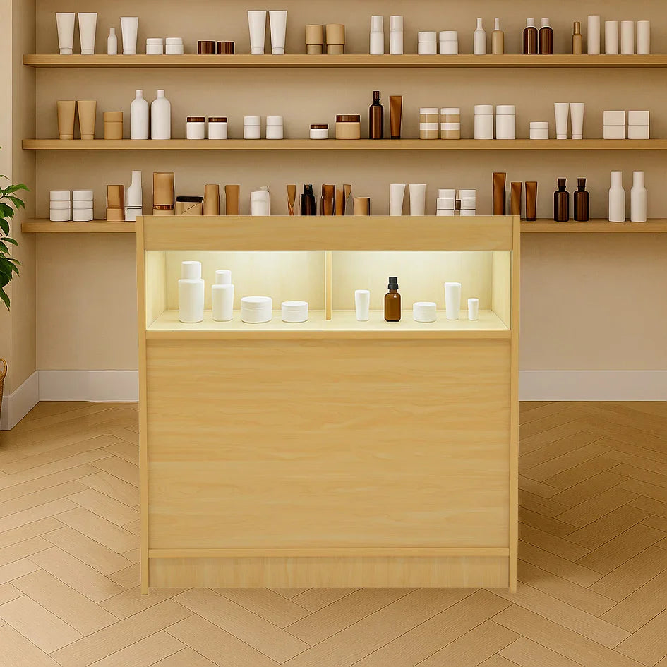 LED retail shop counter B900 in maple wood with illuminated display shelves, showcasing various white and brown containers