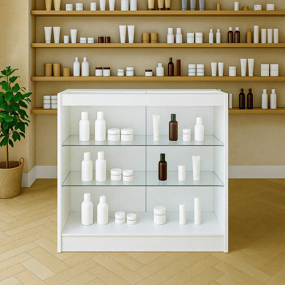 LED retail shop counter K900 in white, featuring glass shelves displaying various white and brown cosmetic containers against a neutral backdrop