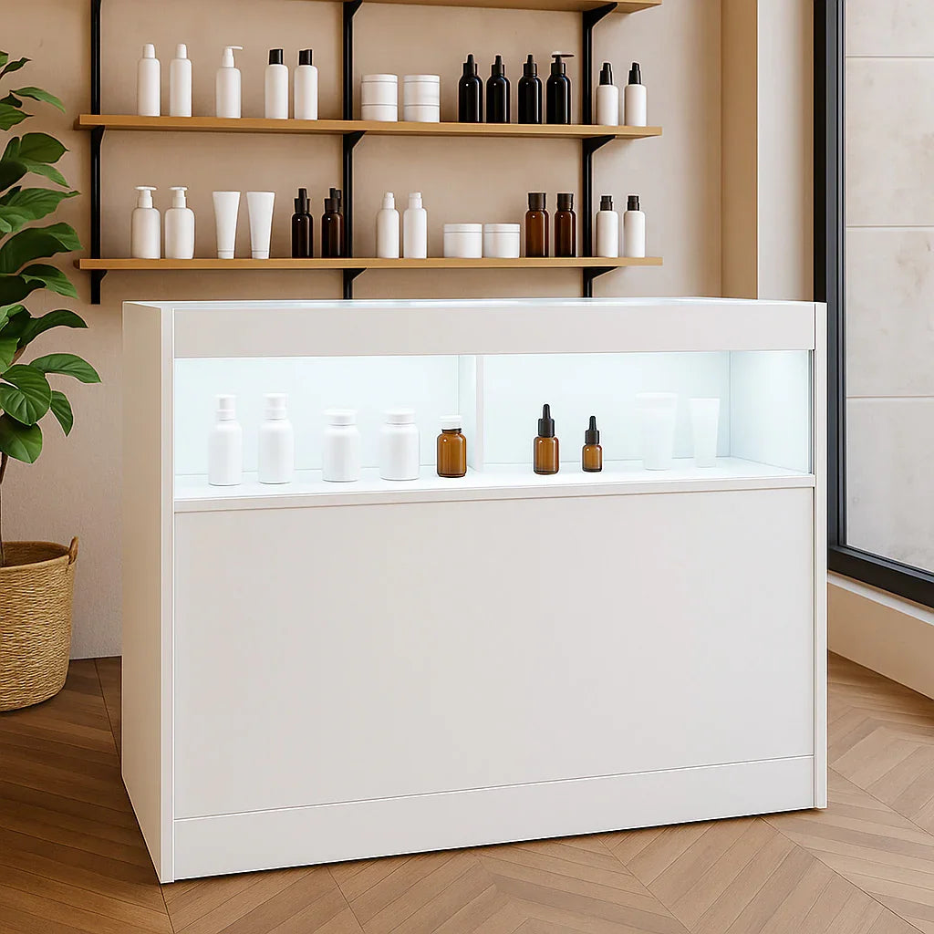 Sleek white LED retail shop counter B1200 showcasing various skincare products against a modern, minimalist backdrop
