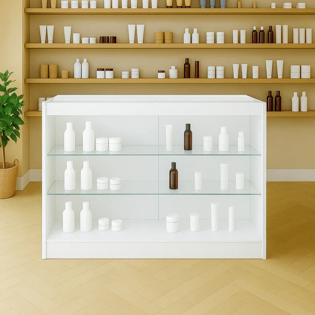 LED retail shop counter K1200 in white with glass shelves, displaying various bottles and jars against a neutral background