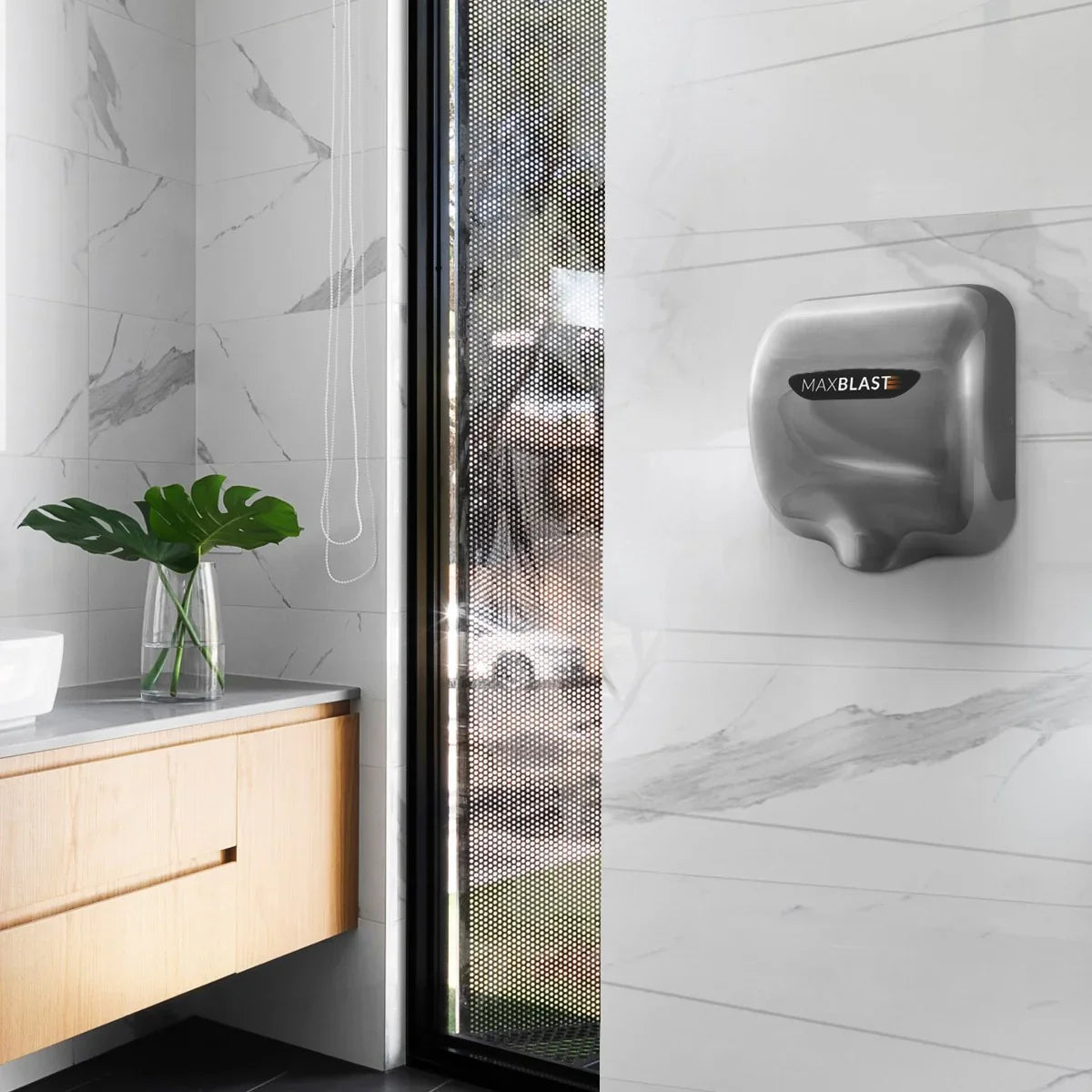 Maxblast automatic commercial hand dryer in sleek silver finish with HEPA filter, mounted on a modern bathroom wall with marble tiles