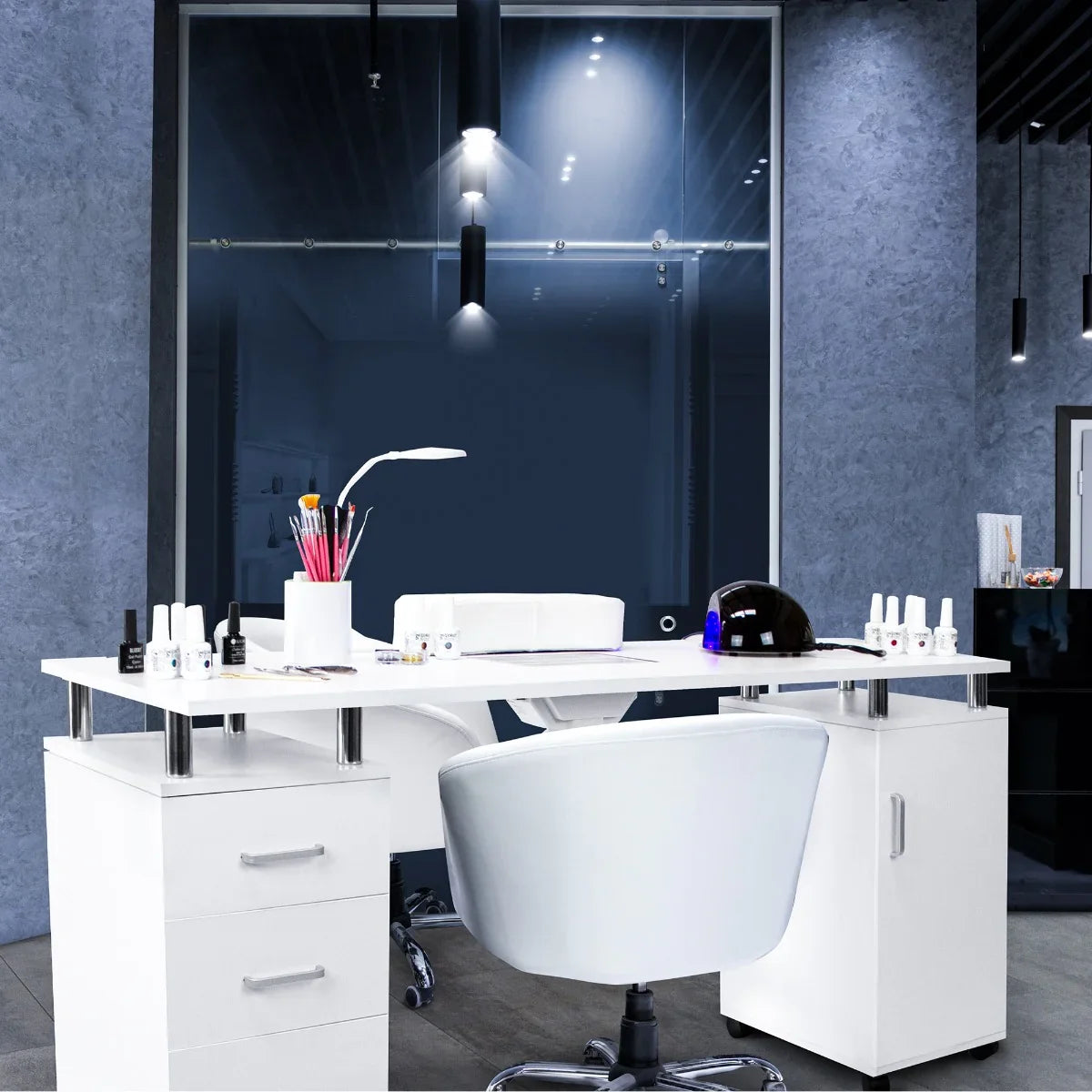 Sleek white professional manicure table with storage drawers, modern chair, nail polish bottles, and a lamp in a stylish salon setting