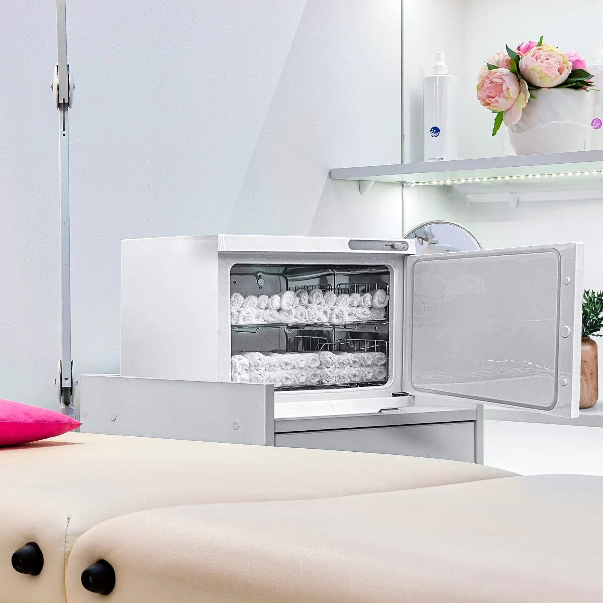 White Hot Towel Warmer with a sleek white exterior, transparent door, and neatly stacked towels inside, set on a light-colored table