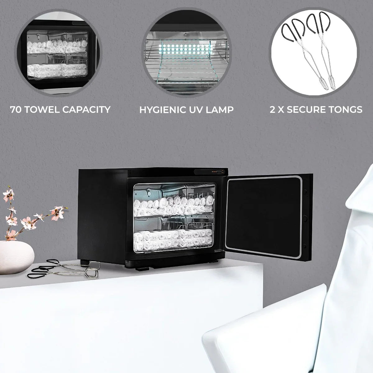 Sleek black hot towel warmer with a 70-towel capacity, hygienic UV lamp, and secure tongs, perfect for spas and salons