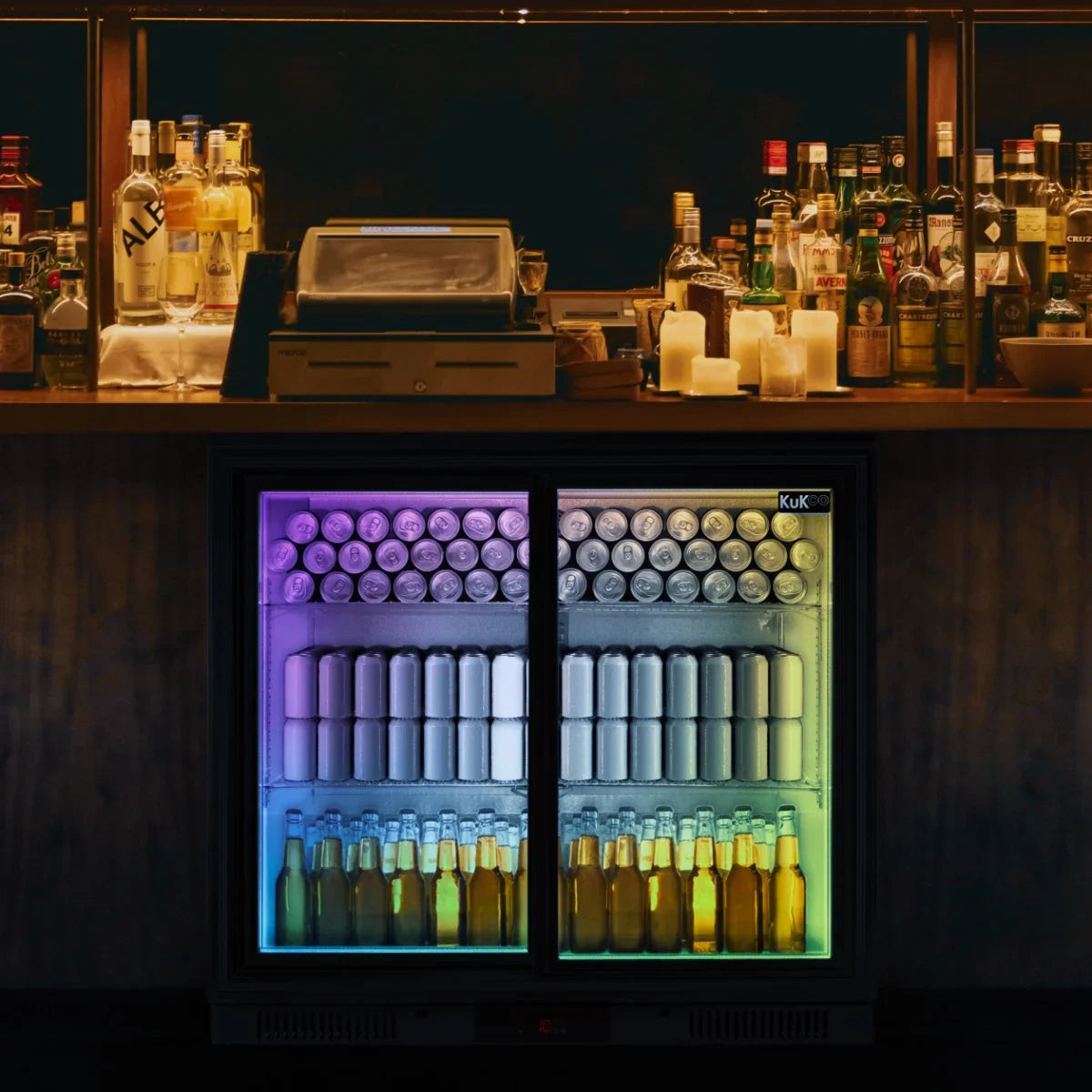 Back bar fridge cooler with sliding double doors, showcasing colorful cans and bottles, illuminated with vibrant LED lights