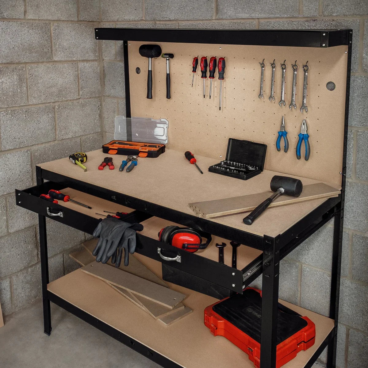 Black workbench featuring a pegboard, drawer, and overhead light, equipped with various tools and a smooth, sturdy surface