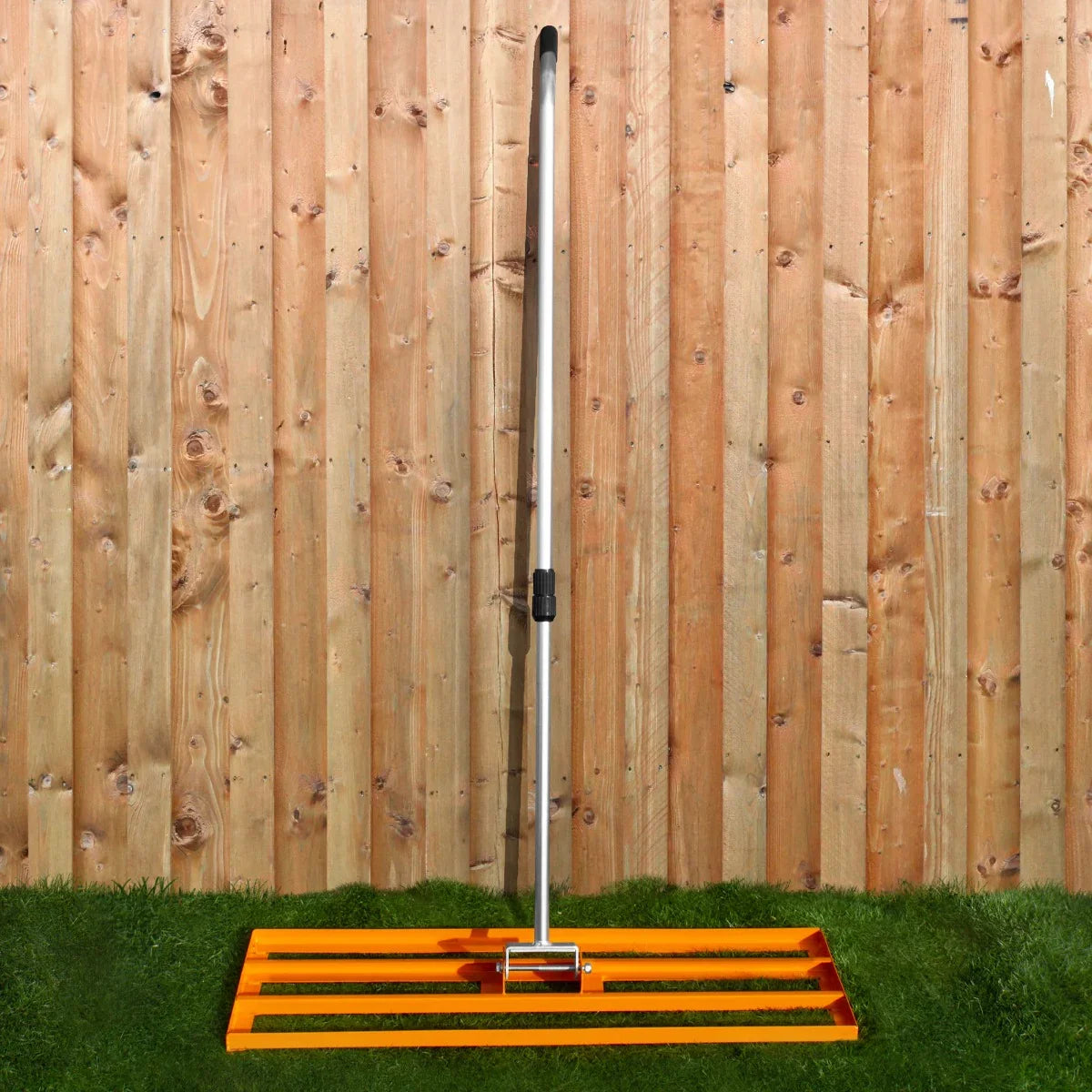 T-Mech Lawn Leveller 100cm in bright orange with a sturdy metal handle, designed for leveling soil and creating a smooth lawn surface