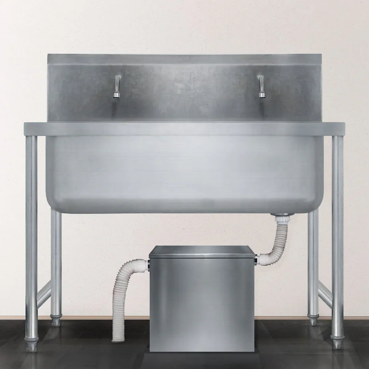Stainless steel KuKoo grease trap with a 35-litre capacity, featuring two faucets and a connected drainage system for efficient waste management