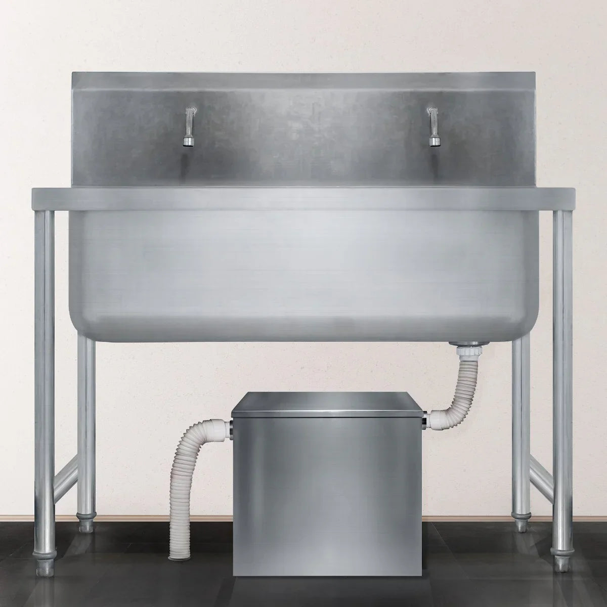 Stainless steel 60-litre grease trap with dual faucets and a connected waste outlet, designed for efficient kitchen drainage