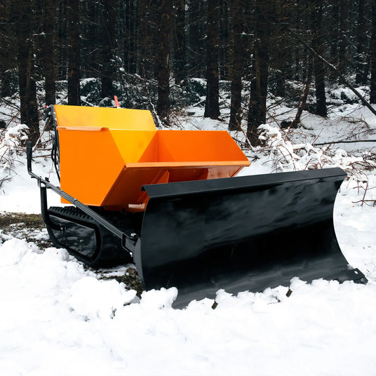 Bright orange snowplow with a black blade, parked on a snowy forest floor surrounded by tall, dark trees