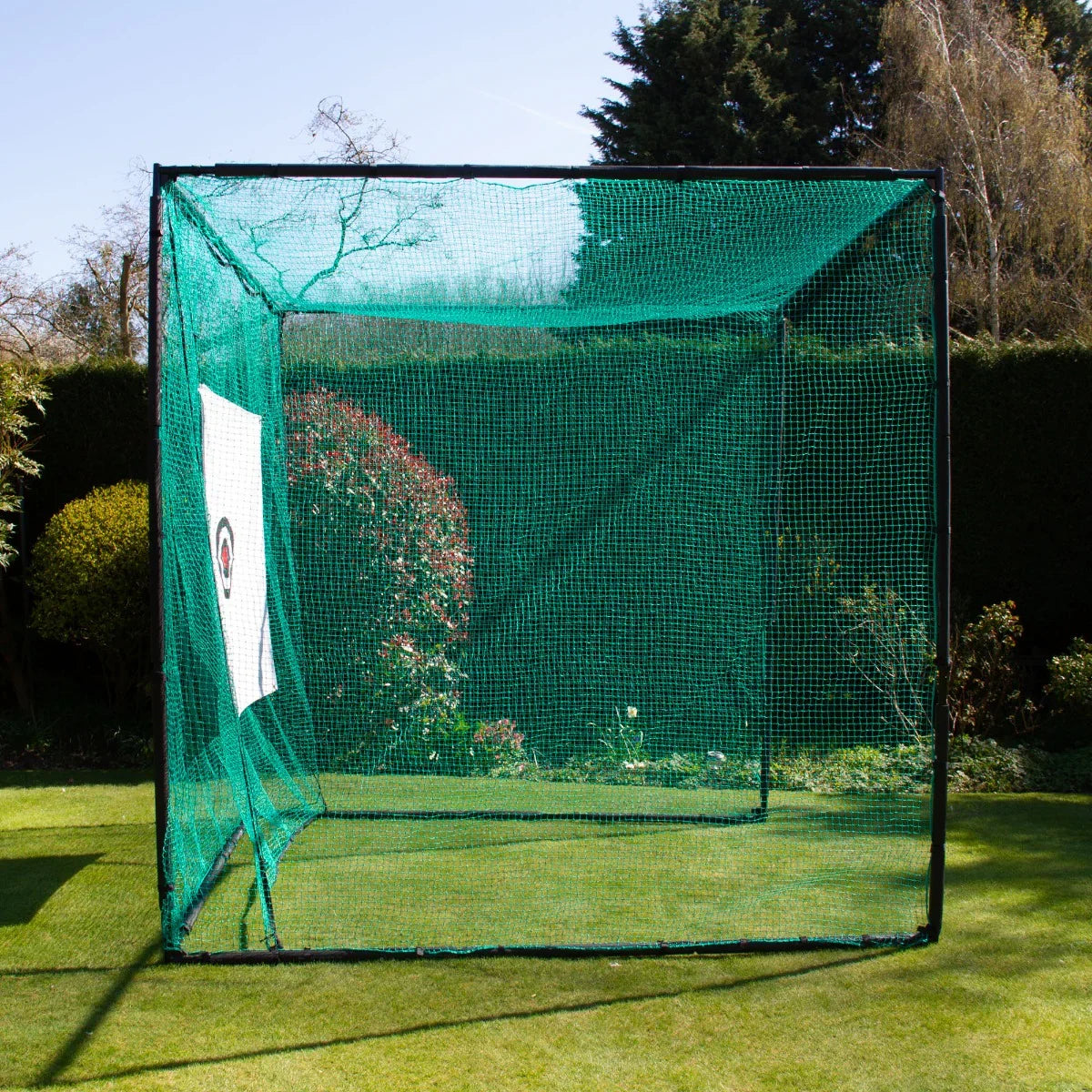 Green golf practice cage with durable netting, featuring a white target panel, set in a lush garden environment