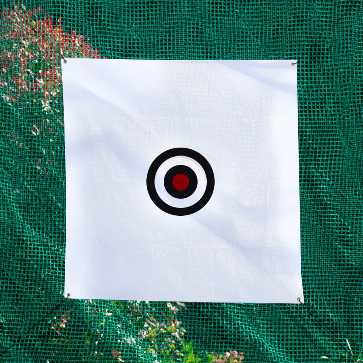 White target with a black and red bullseye, prominently displayed against a green golf practice net, ideal for improving accuracy