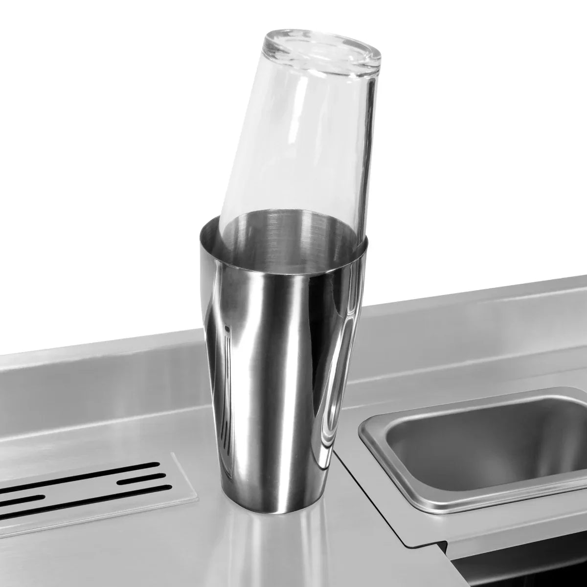 Stainless steel twin cocktail bar station with a tilted glass in a shaker, showcasing sleek design and modern elegance
