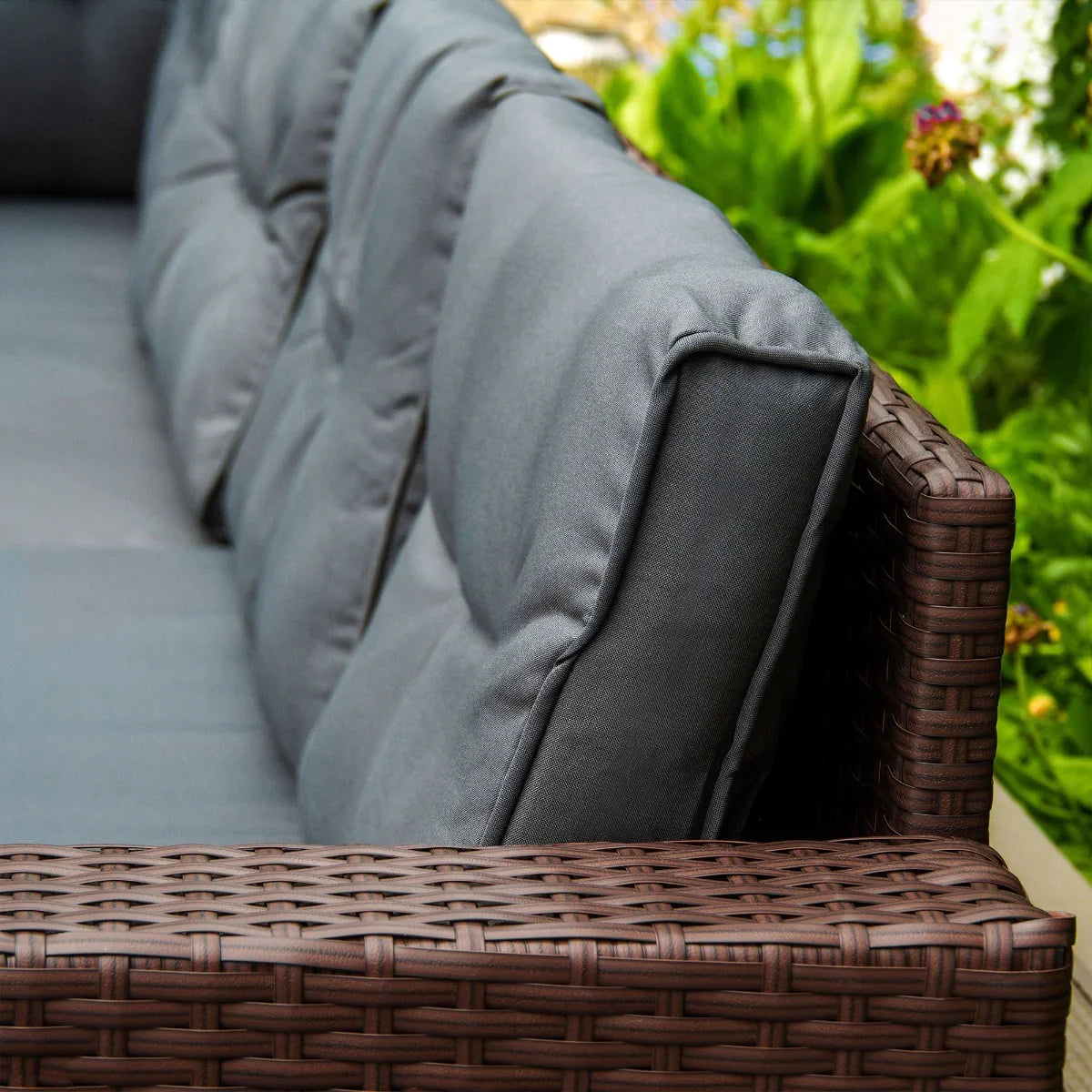 Brown rattan corner set featuring plush gray cushions, showcasing a woven texture and modern design for outdoor comfort