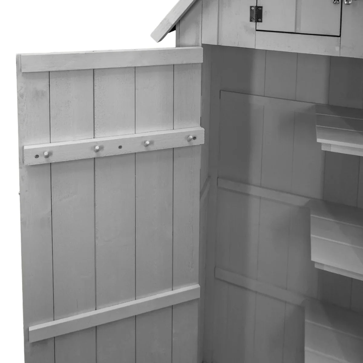 Light grey wooden garden shed interior with shelves, featuring a paneled door and decorative knobs for easy access