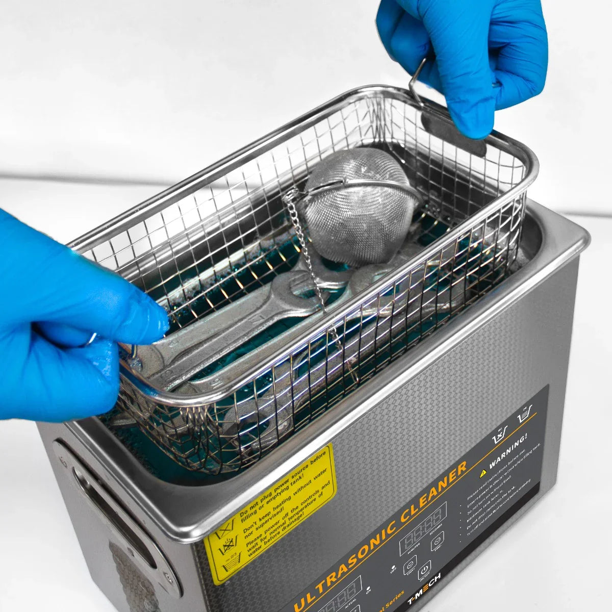 T-Mech Ultrasonic Cleaner 3L with stainless steel basket, blue gloves handling tools, and vibrant cleaning solution inside