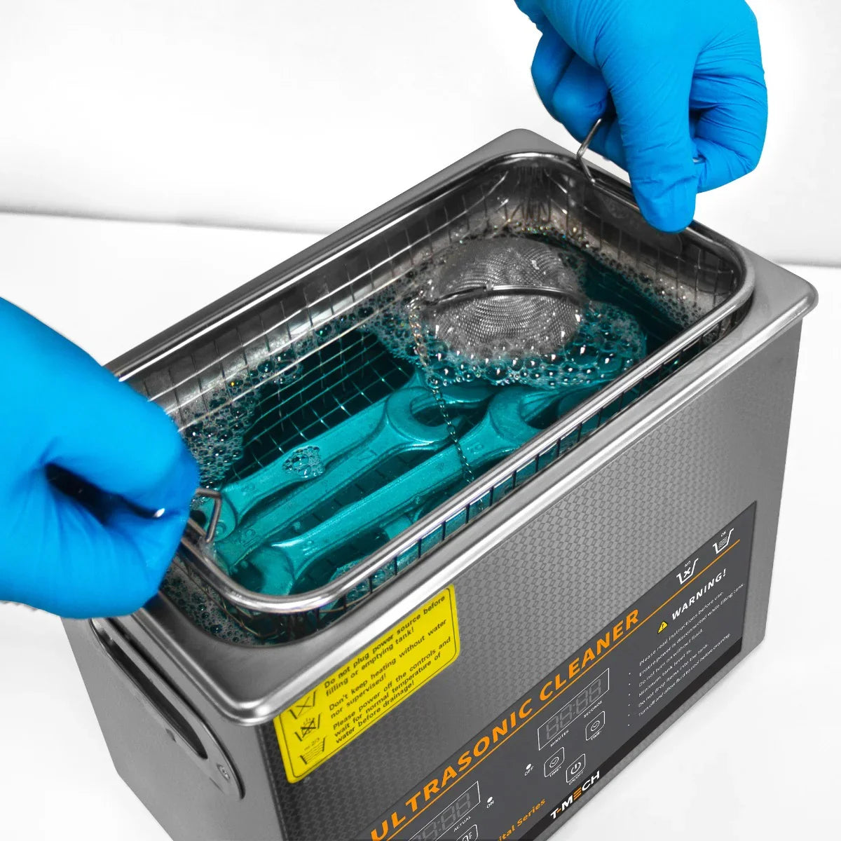 T-Mech Ultrasonic Cleaner 6L with a stainless steel tank, blue cleaning solution, and tools submerged, showcasing effective cleaning power