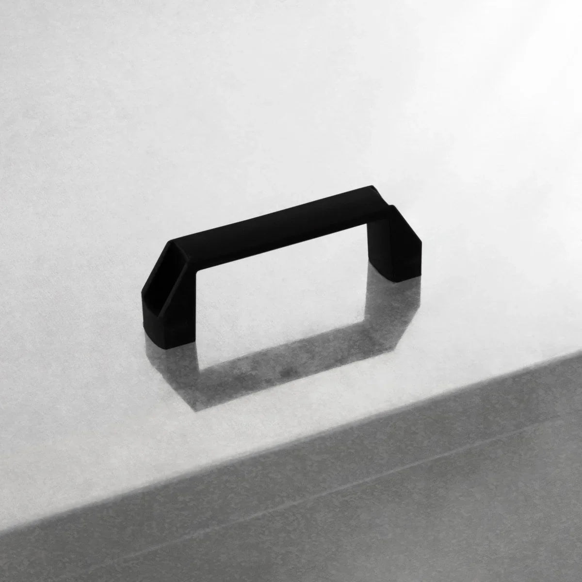 Black handle on a galvanized coal bunker, showcasing a sleek, modern design with a textured finish for easy grip and durability